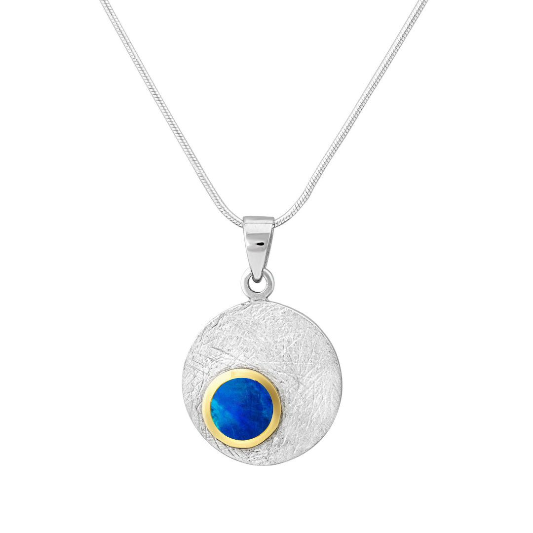 The Selene Necklace Silver - Small by Gallardo & Blaine Designs features a round sterling silver pendant with a gemstone set in a gold bezel, suspended from a delicate silver chain.