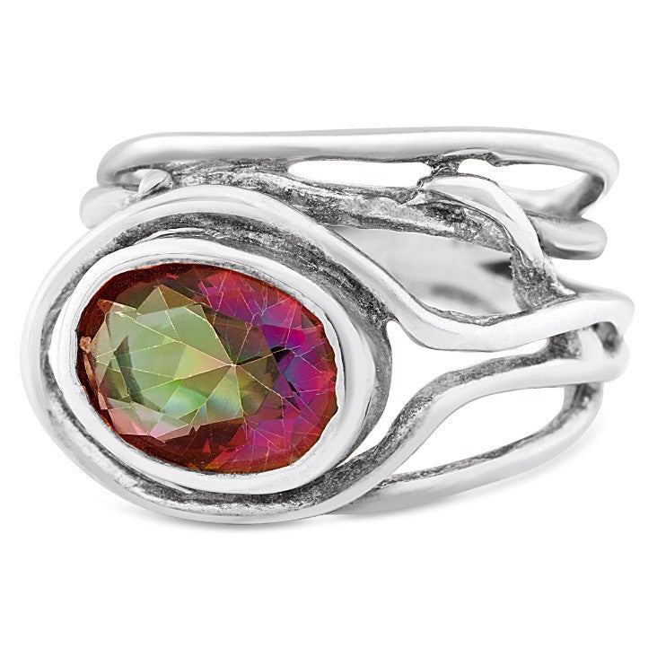A Gallardo & Blaine Designs Fossil Ring in silver & various gemstones features an abstract, flowing design. Its centerpiece is a large, multicolored gemstone with hues of red and green, set in an oval setting. The band splits into two thin, wavy sections,