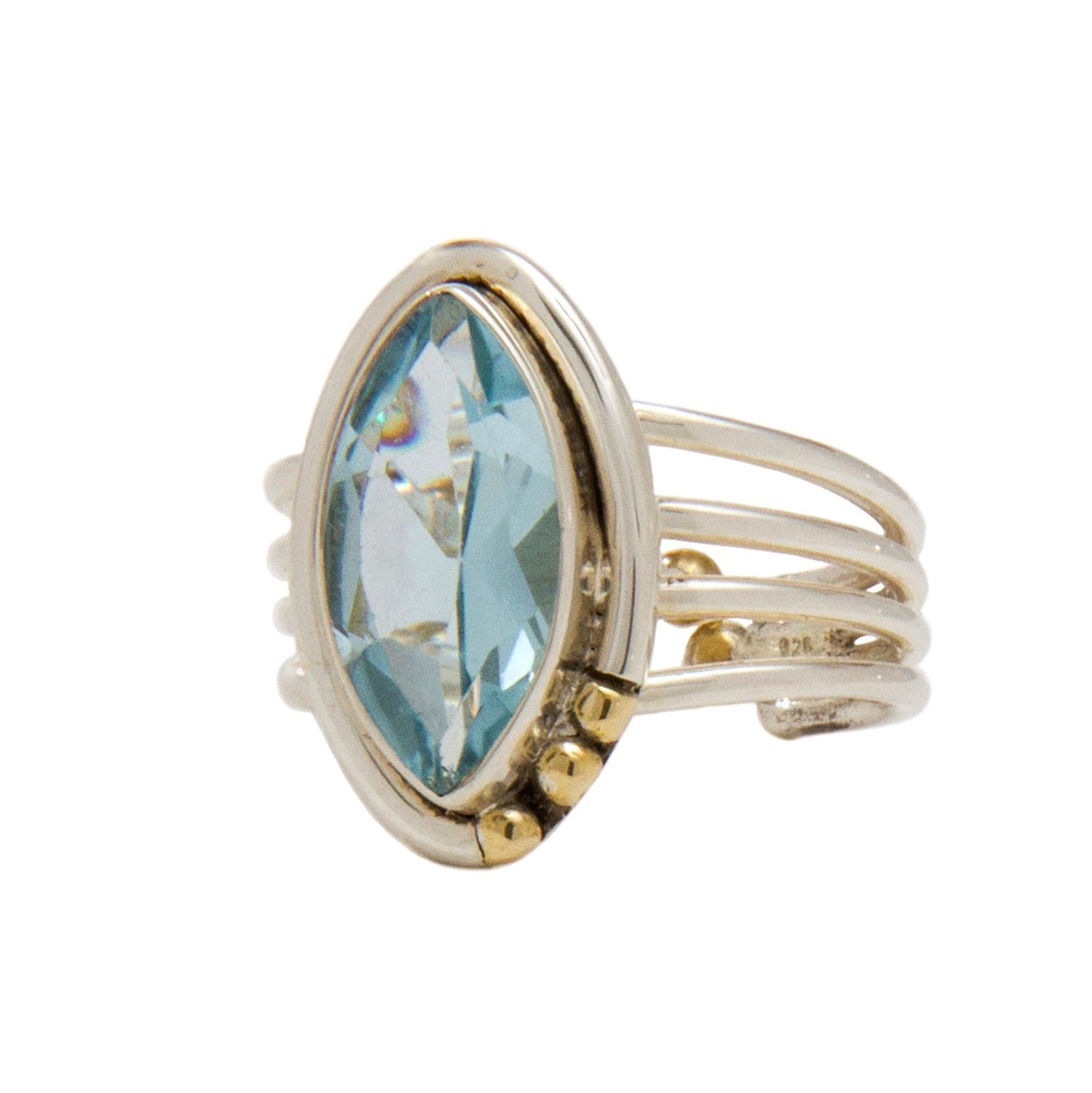A silver Art Deco adjustable ring, the Tulip Ring in various gemstones by Gallardo & Blaine Designs, featuring a large marquise-cut blue gemstone at its center. The band consists of multiple thin loops that combine together near the base of the stone, acc